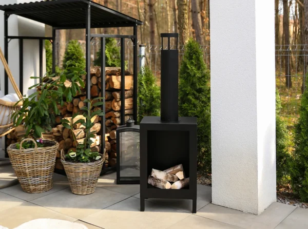 A modern patio with a free-standing Kozen bioethanol fire in matt black